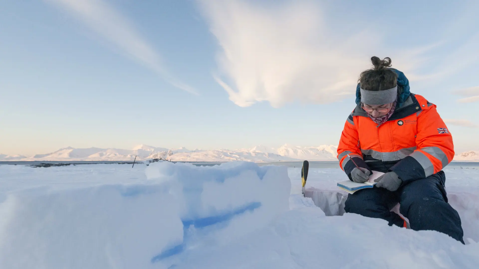 Dorothea Moser carries out an experiment on top of an Arctic glacier. Credit: Iain Rudkin