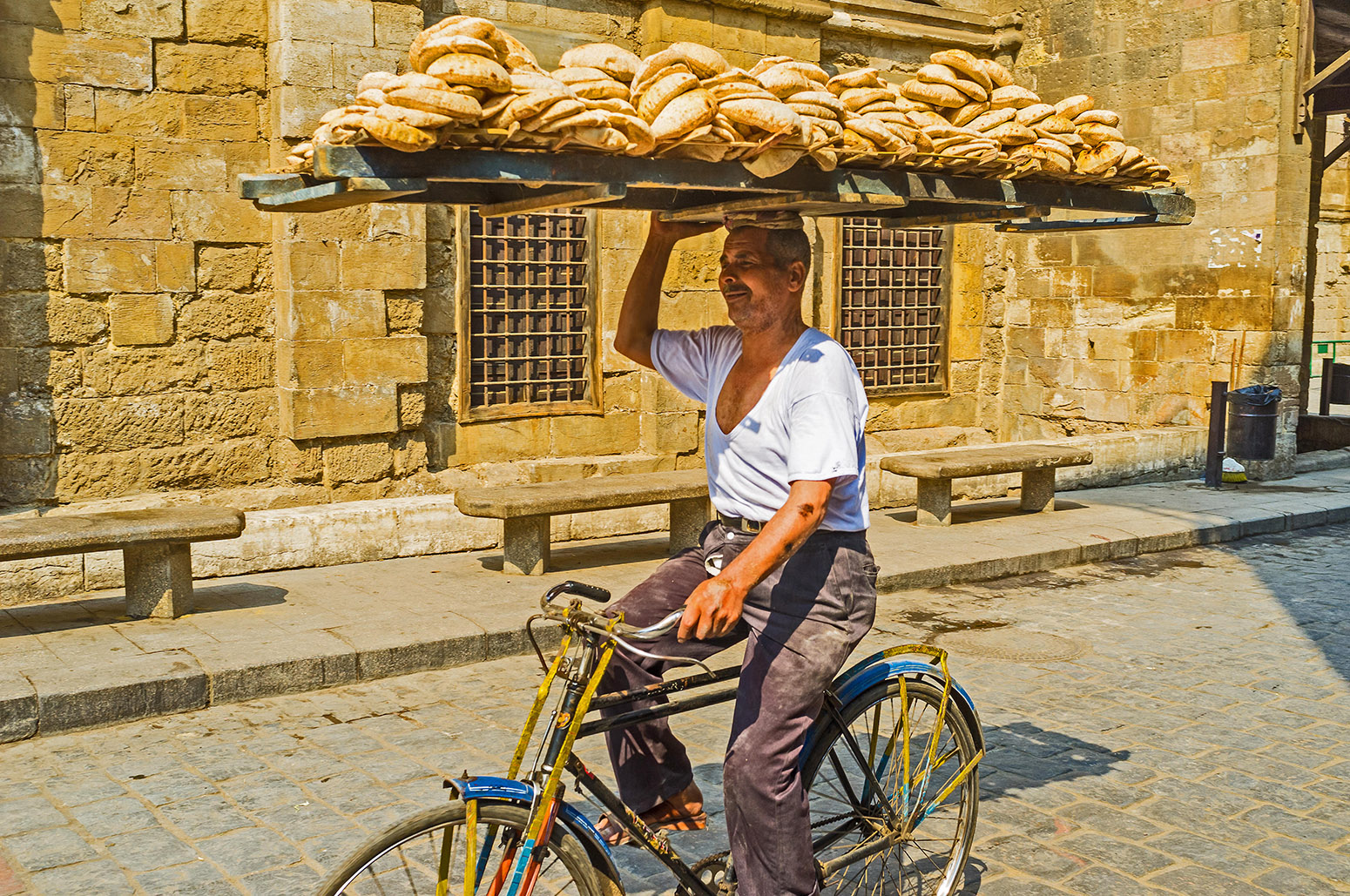 A man delivers flatbread in Cairo, Egypt, where bread is “aish” (life) and was once the cradle of agriculture and is today one of the world’s largest importers of wheat.