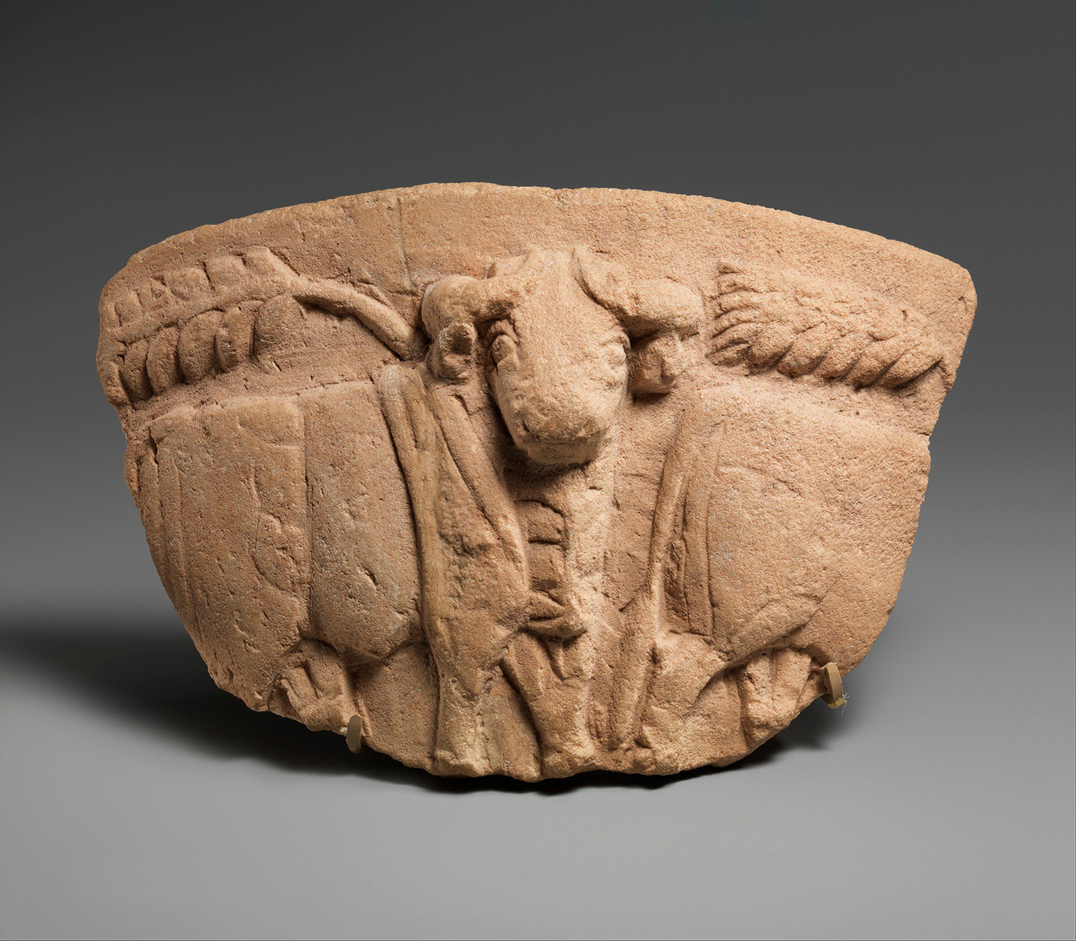 The fragment of a limestone vessel with wheat stalks and a procession of bulls in relief,  Southern Mesopotamia (ca. 3300–2900 B.C). Credit: Met Museum - Bequest of W. Gedney Beatty, 1941.