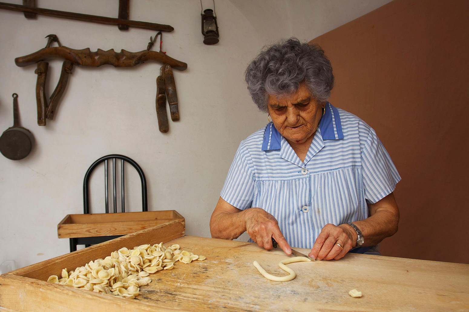 A woman in the Italian region of Puglia makes pasta by hand. Pasta is derived from hard durum wheat. Credit: Hemis / Alamy Stock Photo.