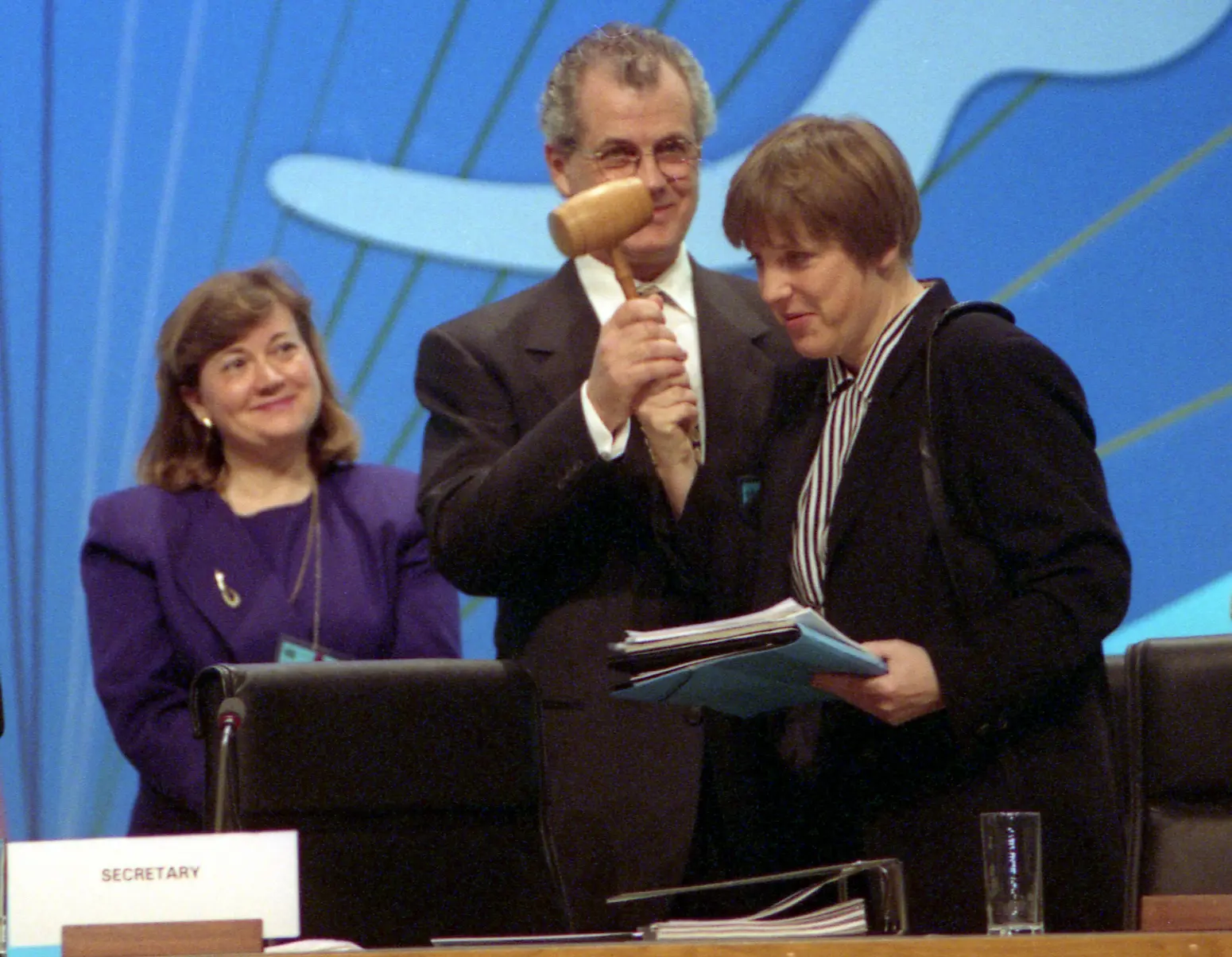 German environmental minister Angela Merkel, right, recieves a wodden mallet to conduct the opening session of the UN summit on Climate Change in Berlin, Germany, 1995