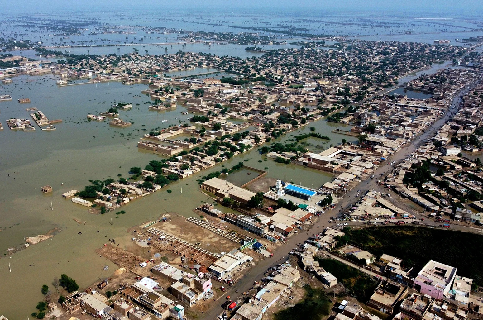 Homes are surrounded by floodwaters in Sohbat Pur city, a district of Pakistan's southwestern Baluchistan province, on 30 August 2022.